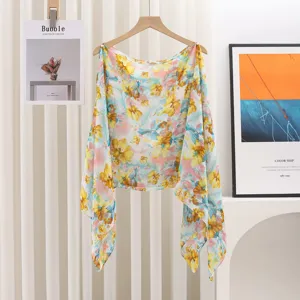 Lightweight floral print shawl with pearl bead details on wooden hanger