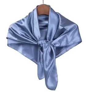 Blue satin silk scarf detail showing fabric texture, elegant knot design for professional wear.
