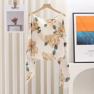 Detailed macro view of the elegant beige floral print and soft fabric of the summer shawl