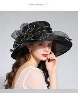 Elegant black organza sun hat with big brim and floral decor, perfect for summer chic.