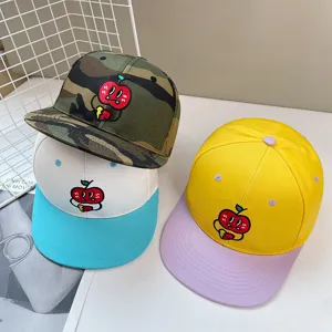 Detail view of trendy hip-hop snapback baseball caps featuring cute embroidered cartoon apple designs.