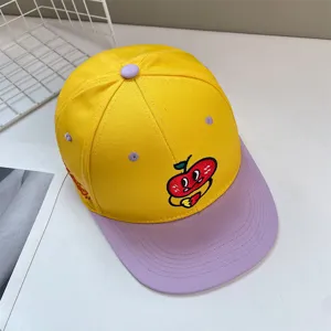 Detailed view of a colorful baseball cap with cute apple embroidery for summer wear.