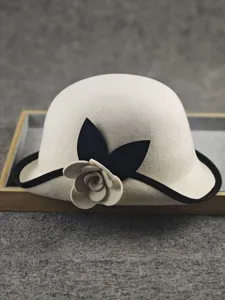 Close-up details of the elegant wool felt bucket hat featuring a chic camellia flower decor.