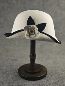 Audrey style wool felt cloche hat with elegant camellia flower and black brim trim.