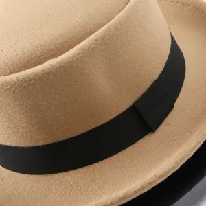 Classic wool felt fedora hat detail, elegant black ribbon band, camel tone, textured fabric.