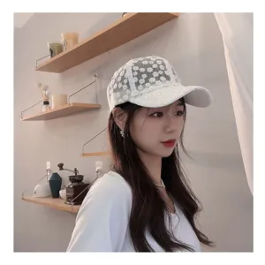 Detailed shot of a sweet white floral embroidered lace breathable baseball cap on model.