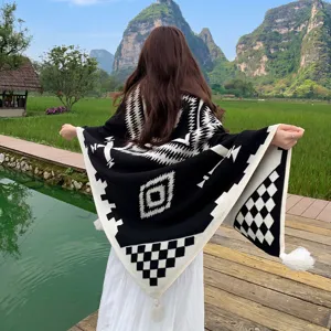 Bohemian knitted blanket detail view showing black and white geometric pattern design.