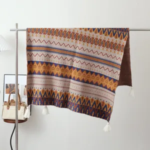 Boho knitted blanket detail showing intricate geometric patterns and decorative tassels.