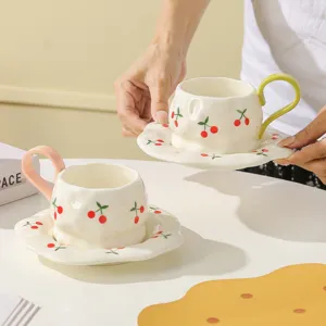Hand-painted ceramic cherry coffee cup and saucer set, elegant afternoon tea detail view.