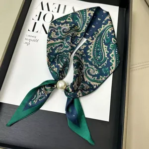 Close-up detail of vintage paisley silk skinny scarf with elegant pearl magnetic buckle accent.