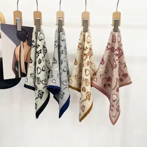 Detailed shot of the retro French bow print velvet herringbone small square scarf for women.
