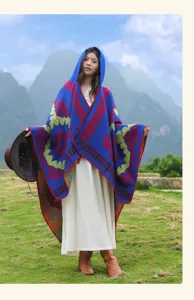 Retro ethnic style hooded cloak detail, blue knitted shawl with red green geometric patterns.