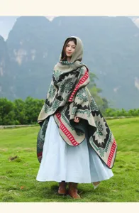 Detailed view of the retro ethnic hooded cape showing intricate geometric patterns and tassel trim.