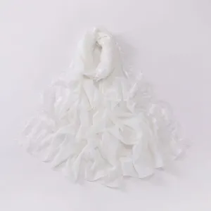 Detail view of the elegant white chiffon scarf featuring delicate eyelash fringe and soft fabric.