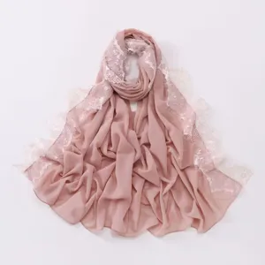 Pink chiffon hijab scarf featuring delicate white eyelash lace trim detail and soft drape.