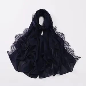 Detail view of the dark blue chiffon hijab scarf featuring delicate lace eyelash trims.