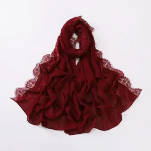 Detailed view of the burgundy chiffon hijab featuring delicate eyelash lace trim and soft fabric.
