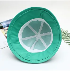 Green bucket hat interior detail showcasing clean white inner straps and breathable fabric structure.