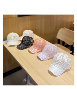 Detail shot of sweet floral embroidery lace baseball caps, breathable mesh sun hat display.