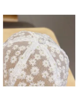 Daisy embroidery lace baseball cap crown detail, breathable summer sun hat close-up view.