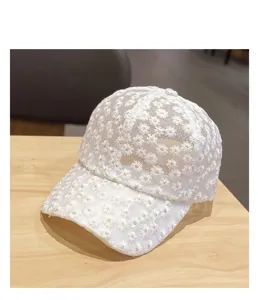White lace floral embroidered baseball cap with breathable mesh design for summer sun protection.