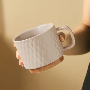 Ceramic coffee mug detail view, textured diamond pattern and brown base design, elegant cup.