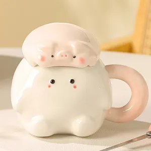 Cute ceramic pig mug detail close up, showing adorable animal shape and smooth pink handle.