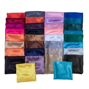 Plain satin square scarf detail view showing smooth texture and vibrant color swatch variety.