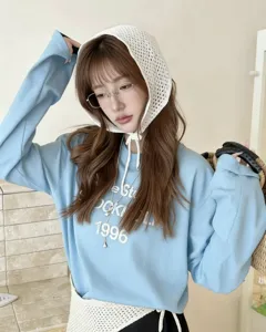 Stylish women's blue sweatshirt paired with a white hollow-out knit triangular hood scarf.