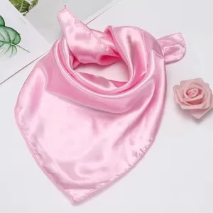 Pink silk scarf detail, smooth texture, lightweight square scarf for summer sun protection.