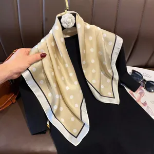Elegant champagne polka dot silk square scarf, versatile spring and summer fashion accessory.