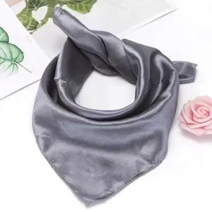 Detailed close-up shot of a solid gray silk scarf, elegant and versatile for summer styling.