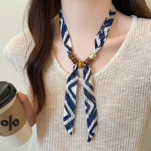 Blue patterned skinny scarf necklace with wooden beads, elegant choker accessory for women.