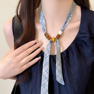 Blue plaid fabric necklace with colorful wooden beads, chic adjustable scarf accessory for women.