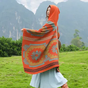 Retro ethnic style hooded knitted poncho cape, perfect for travel photography and casual wear.