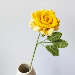 Handmade crochet yellow rose flower detail close-up view, showing delicate yarn texture.