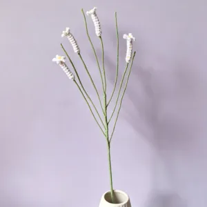 Handmade crochet white flower stem for home decor, exquisite knitted botanical gift for rooms.
