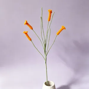 Handmade crochet trumpet vine flower detail view, vibrant orange wool craft for decor.