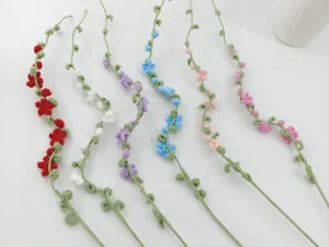 Detailed shot of handmade crochet flower branches in assorted colors for DIY floral arrangement.