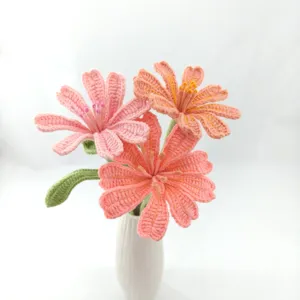 Handmade crochet flower bouquet detail, exquisite knitted pink floral decor in white vase.