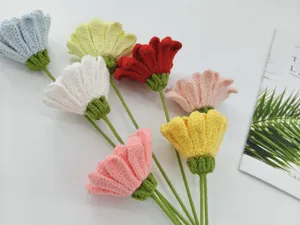 Close-up detail shot of handmade crochet gerbera flowers bouquet in multiple colorful yarns.