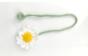 Handmade crochet daisy bookmark detail, cute green stem and floral design for reading.