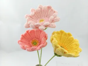 Handmade crochet gerbera flower bouquet detail view, beautiful knitted wool floral decor.