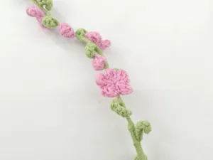 Handmade crochet flower vine detail shot, pink floral decoration for DIY crafts and gifts