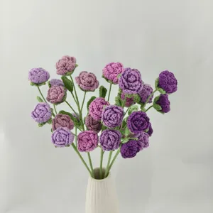 Handcrafted crochet rose bouquet detail, multi-color purple flowers in a white ceramic vase.