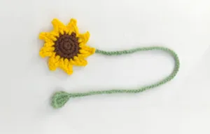 Handmade crochet sunflower bookmark detail view, cute woolen flower page marker style.