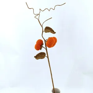 Handmade crochet persimmon branch detail view, knitted floral decor for home table display