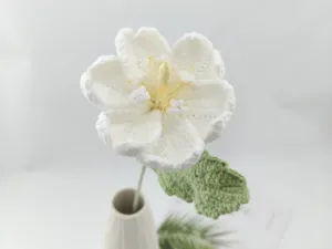 Handmade crochet white flower detail close-up, lovely knitted yarn floral decor for home.