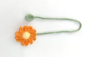 Handmade crochet flower bookmark detail showing fine yarn texture and neat stitches.