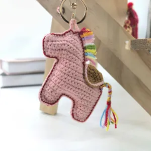 Handmade crochet pink pony keychain with colorful mane and cute metal keyring for bags.